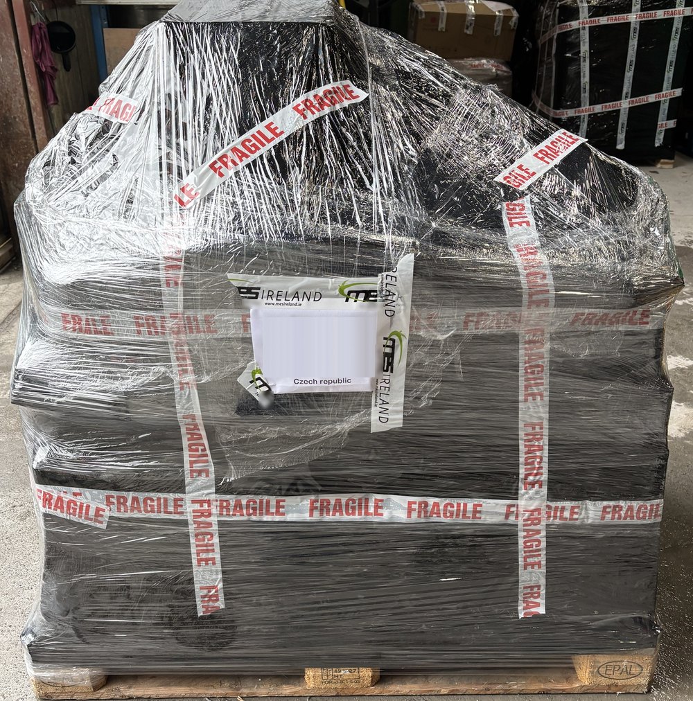 A pallet of Christmas stock in black wrap and FRAGILE tape, labelled for the Czech Republic